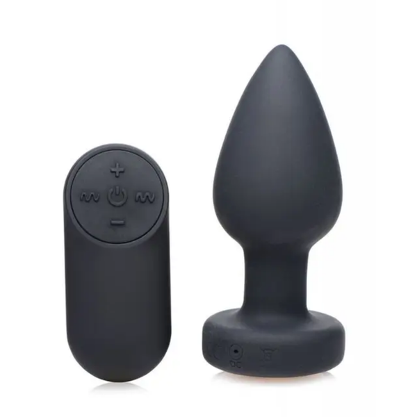 Set product view showing the matte black silicone small anal plug standing upright next to its wireless oval remote control.