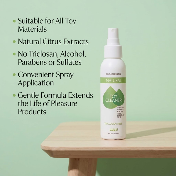 Product marketing graphic featuring the 4 fl oz spray bottle standing on a wooden surface alongside green bullet points highlighting key features: suitable for all toy materials, natural citrus extracts, no triclosan/alcohol/parabens/sulfates, convenient spray application, and gentle formula.