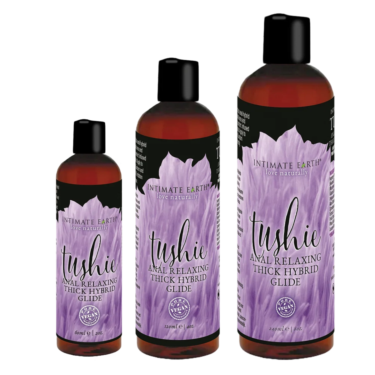 Size comparison view showing three amber bottles of Intimate Earth Tushie thick hybrid glide standing side by side in 60 ml (2 fl oz), 120 ml (4 fl oz), and 240 ml (8 fl oz) capacities. Hauptbild