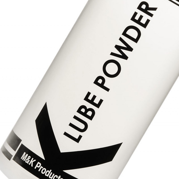 A close-up, angled shot of the K-Lube Powder label. The focus is on the crisp, black sans-serif typography of the words "LUBE POWDER" and the sharp geometric lines of the "K" logo against the smooth white background of the bottle.