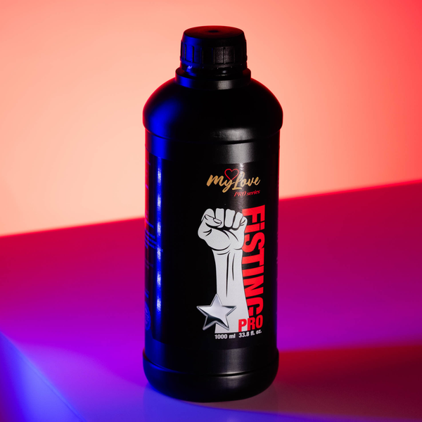 Front view of the MyLove Fisting Pro Gel 1000 ml bottle set against a dramatic dual-tone pink and blue lighting backdrop. The raised fist graphic and red "FISTING PRO" label stand out prominently.