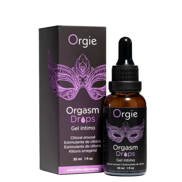 A black box and an amber glass dropper bottle of Orgie Orgasm Drops intimate gel, both featuring a purple Venetian mask design.