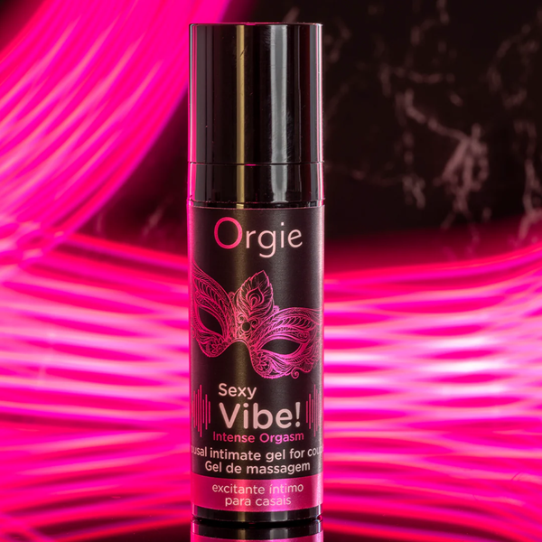 A black bottle of Orgie "Sexy Vibe!" intense orgasm gel centered against a dark background with vibrant, neon pink light streaks.