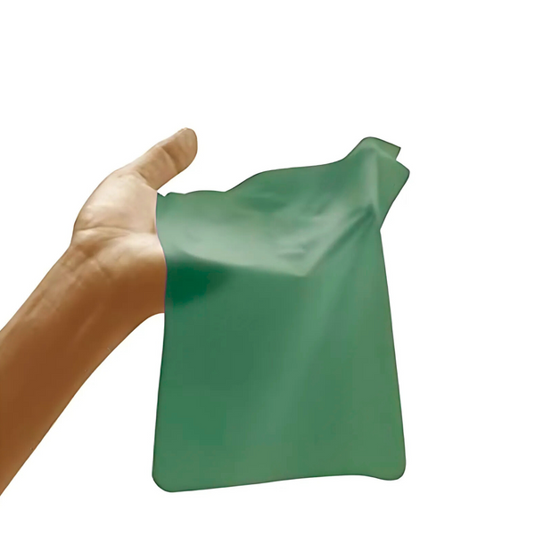 Hand holding a green mint-flavored dental dam.