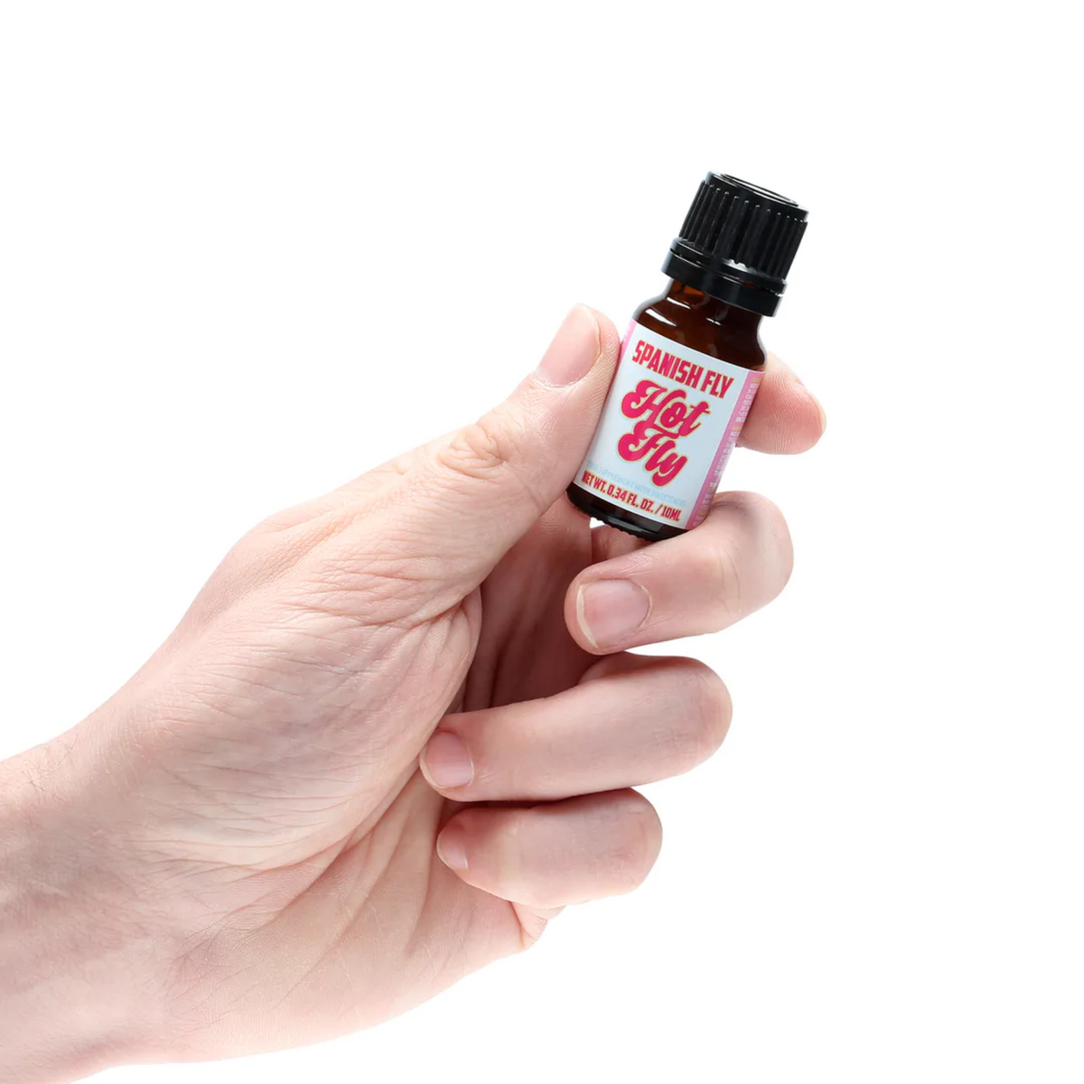 A person's hand is holding the small, brown dropper bottle of Spanish Fly Hot Fly. 
