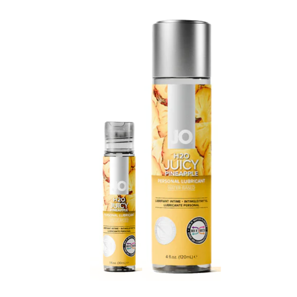 Two bottles of System JO H2O Juicy Pineapple flavored lubricant are displayed side-by-side against a white background, with the smaller 1 fl. oz. bottle on the left and the larger 4 fl. oz. bottle on the right. Both feature clear caps and labels decorated with vibrant chunks of yellow pineapple.