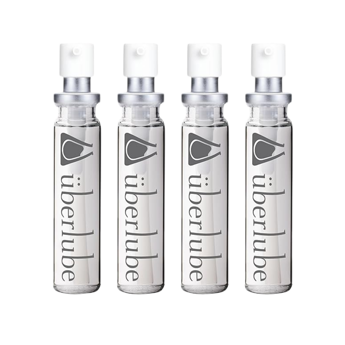 Four transparent glass spray bottles of Überlube lubricant, each with "überlube" and a stylized eye logo printed vertically, stand in a row. These travel-friendly WorldCondoms offerings provide discreet, on-the-go intimacy. Hauptbild