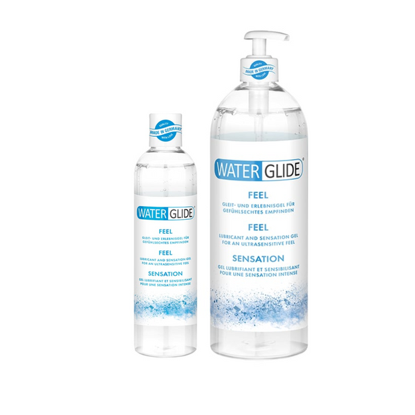 An image of two bottles of Water Glide Feel gel. The bottle on the left is smaller and 300ml, and the bottle on the right is larger with a pump dispenser and is 1000ml. Both bottles are clear, filled with a transparent gel, and have similar blue and white labels. The background is solid white.
