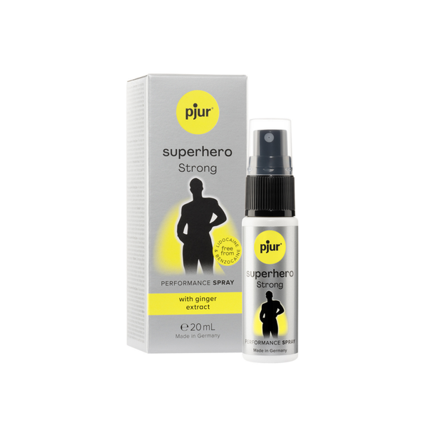 A gray box and a small white spray bottle of Pjur Superhero Strong performance spray are positioned against a white background. 